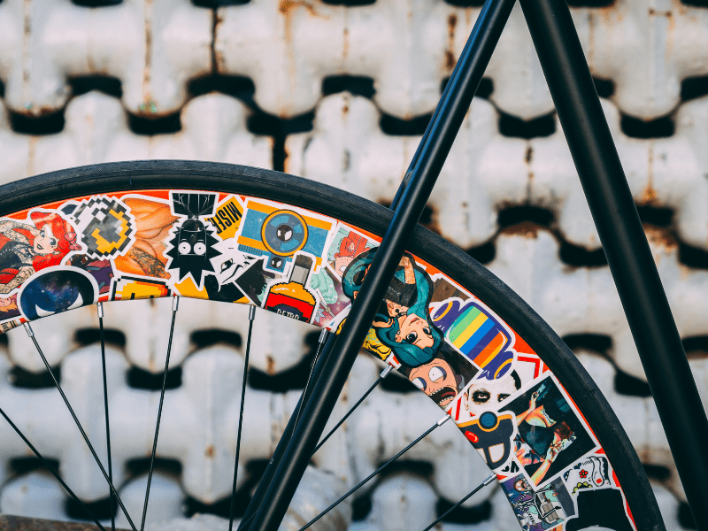 Close up of bike on wall with stickers.
Turn your hobby into a small business and sell profitable home made products. Here are 3 in demand profitable products to sell online and start a side hustle or small business on Etsy or Shopify. 