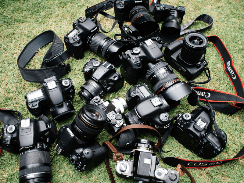 Canon cameras with lenses on the grass